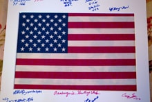 American flag print covered with signatures and personal messages from veterans and participants at the 2022 Veterans Upland Bird Hunt