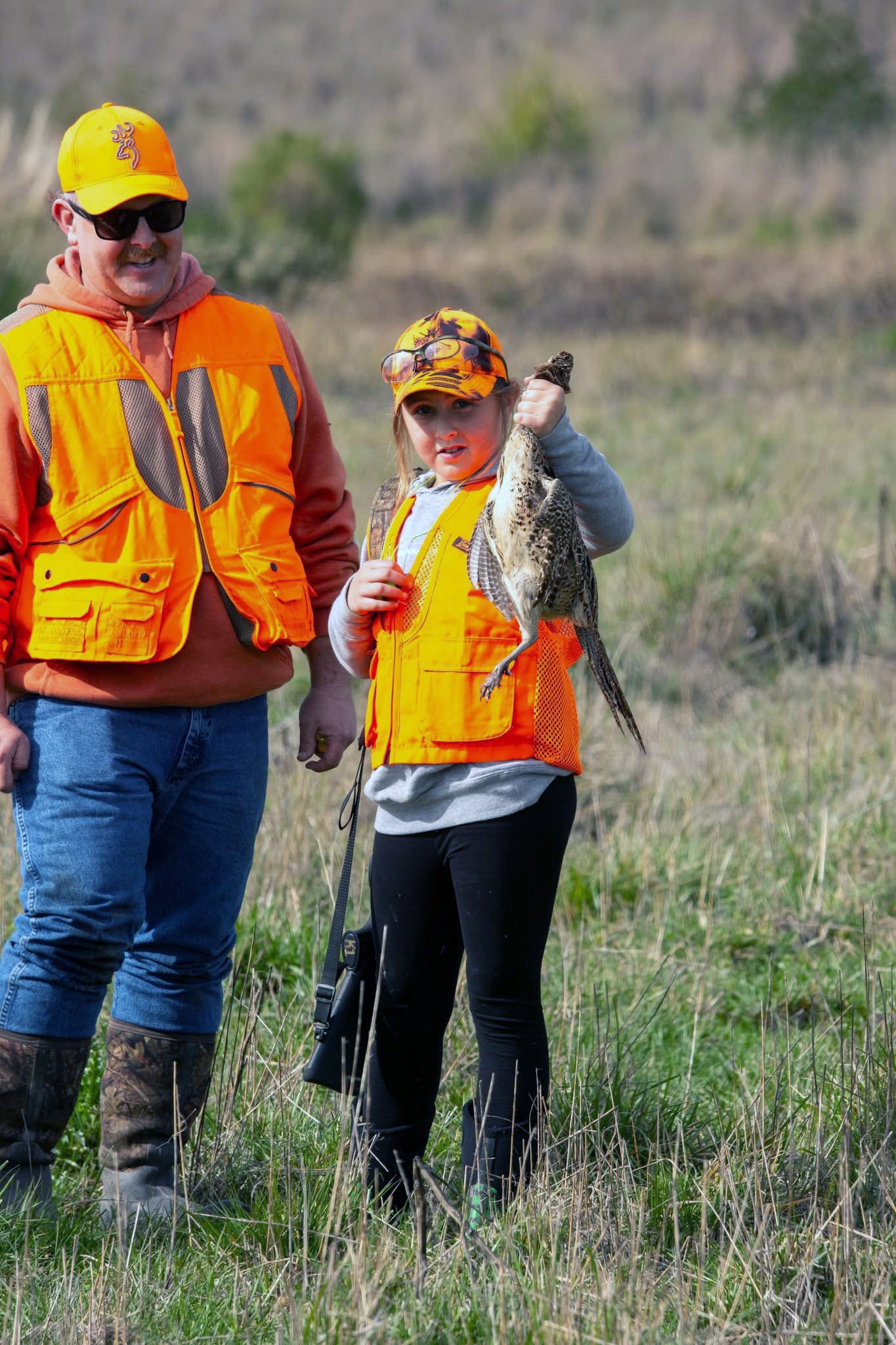 Man and child fishing together with a caught trout at the 2025 Youth Mentor Hunt multi-activity day
