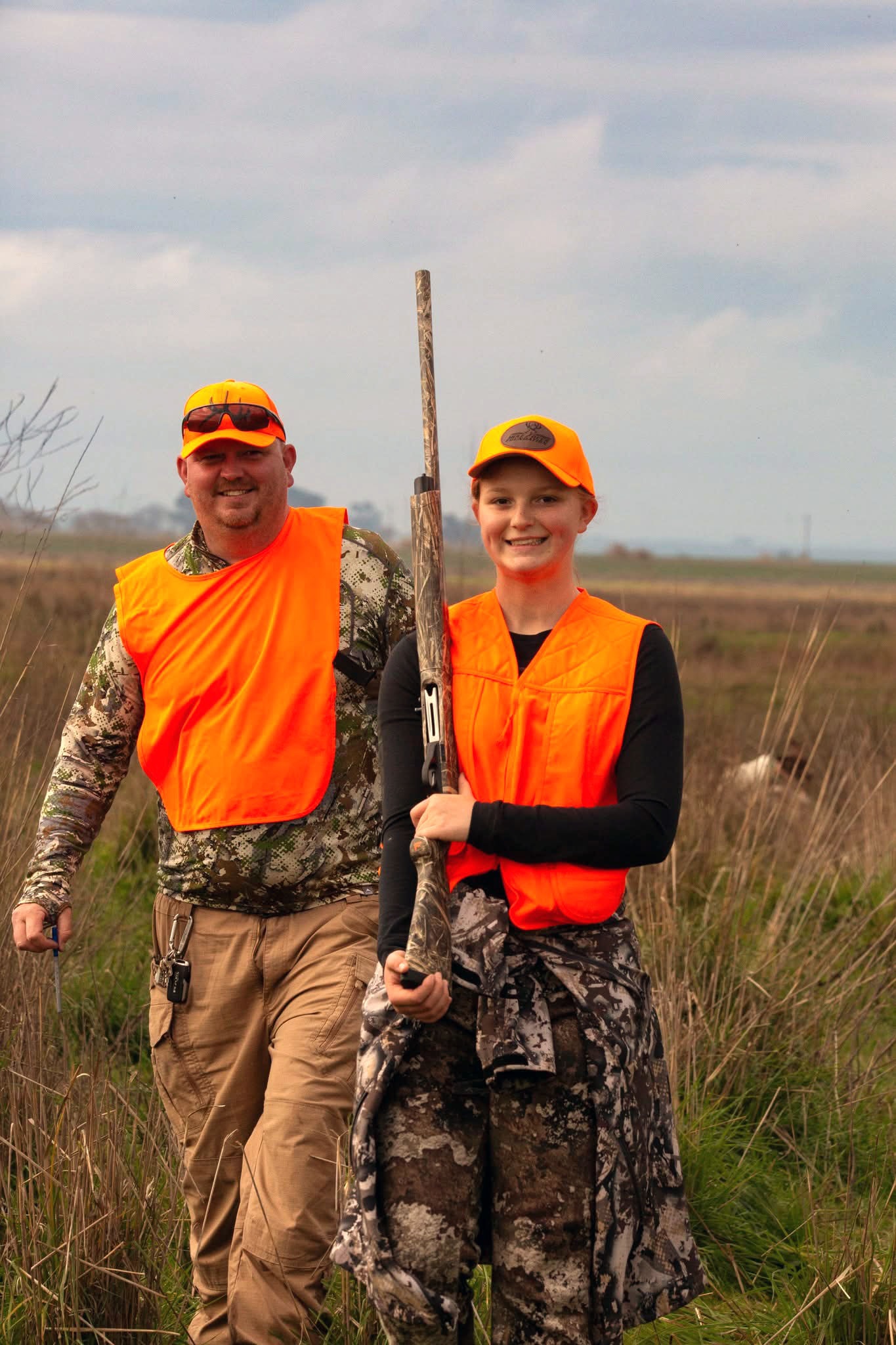 Young female hunter posing with a harvested pheasant in the field at the 2025 Youth Mentor Hunt