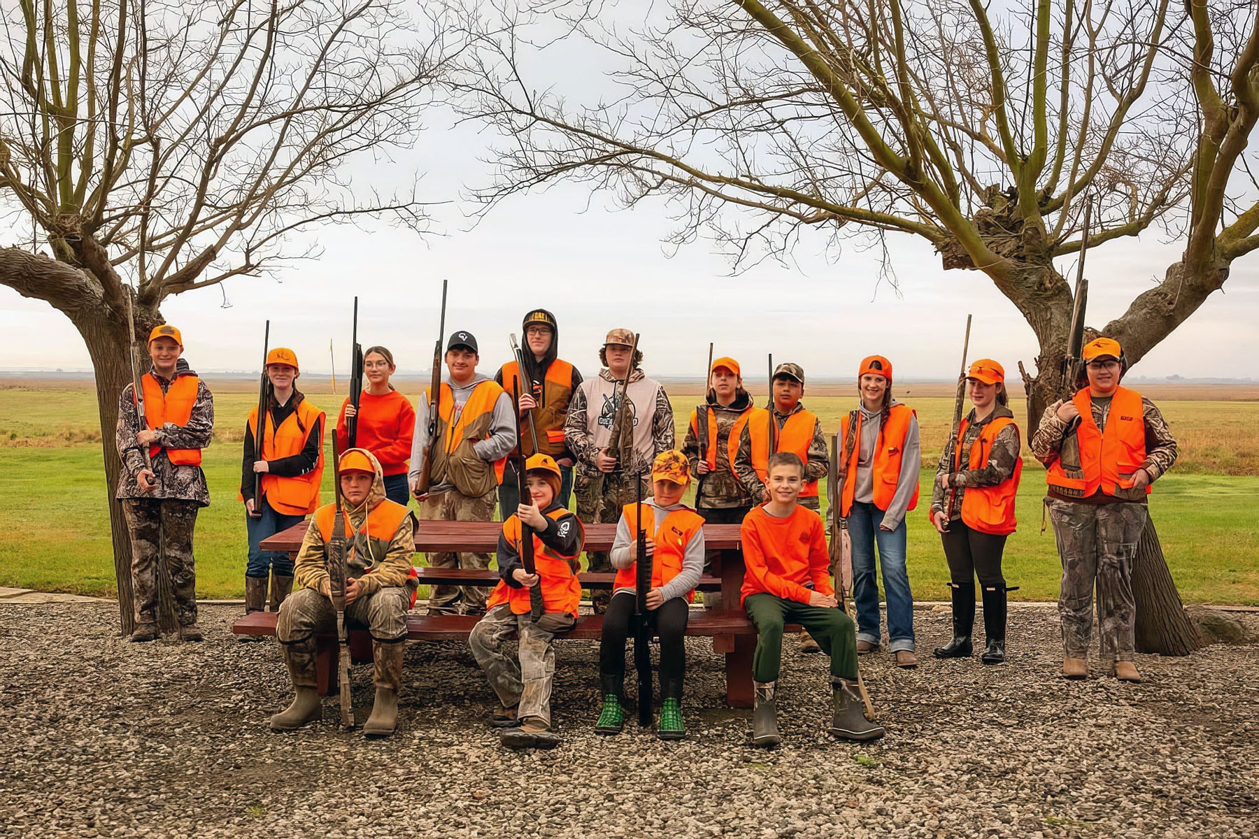 Hunting group posing together under a bare tree at the 2025 Youth Mentor Hunt