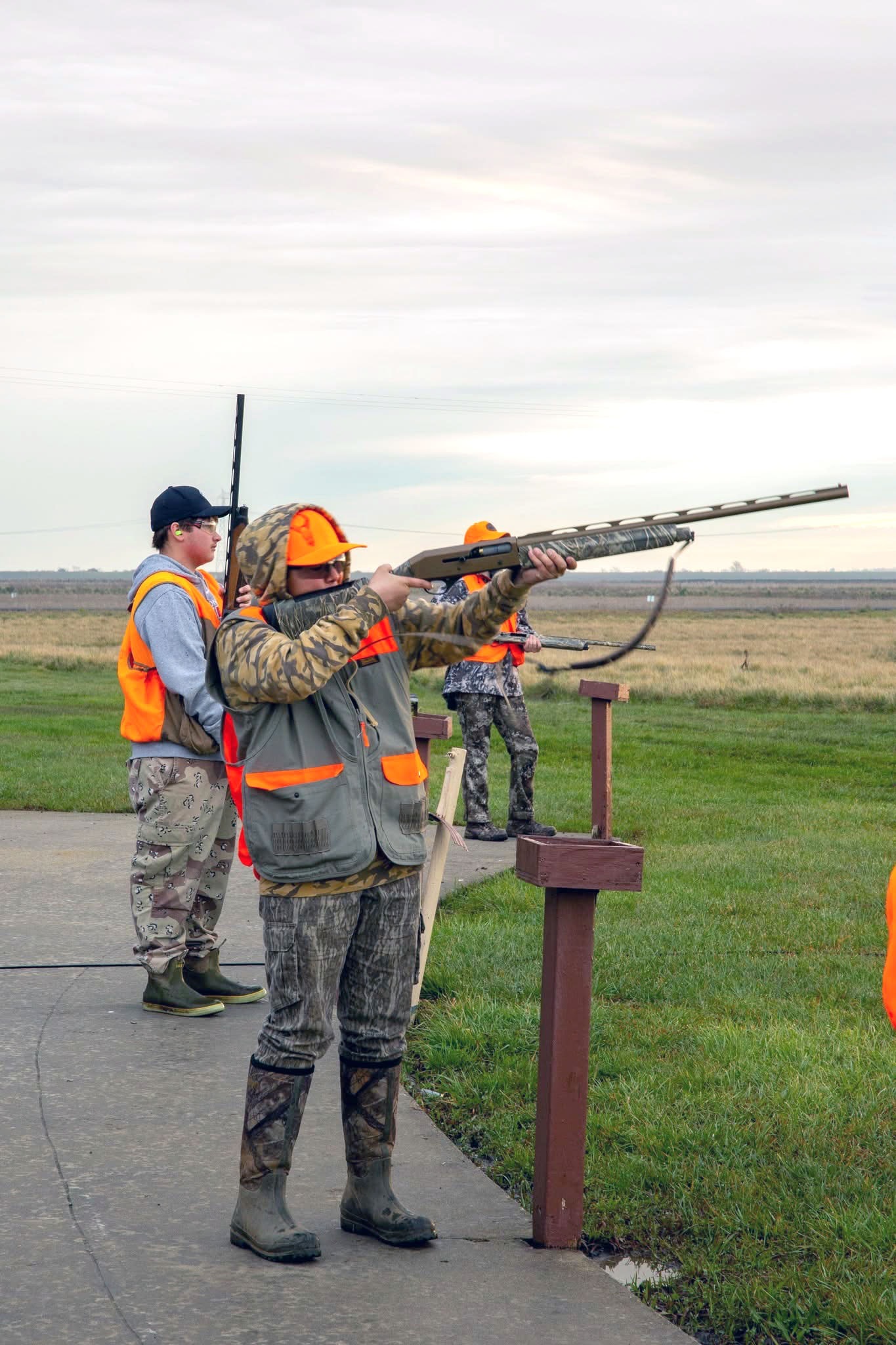 Youth hunters shooting clay targets at an outdoor range with mentors at the 2025 Youth Mentor Hunt