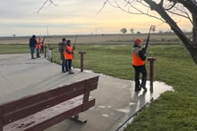 Youth hunter at a shooting station with a mentor providing instruction at the 2025 Youth Mentor Hunt